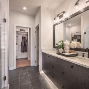 Spa-like primary bathrooms with dual sink vanities and luxe showers with seats