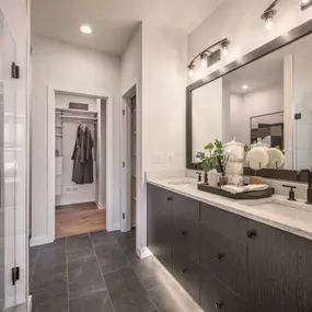 Spa-like primary bathrooms with dual sink vanities and luxe showers with seats