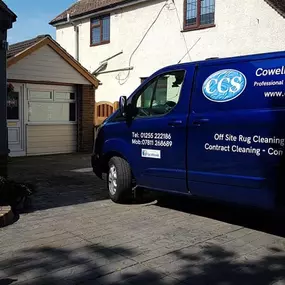 Cowell's Cleaning Services logo: our van outside a customers house in wivenhoe