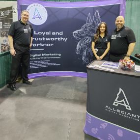 Small Business Expo in Dallas, Texas with the Allegiant Digital Marketing Team posing at tradeshow booth