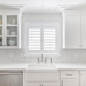 This kitchen is so bright and fresh! We wanted to add another wood element to match the ceiling and cabinetry—and our Plantation Shutters work perfectly!