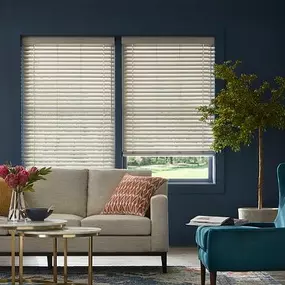 Our Faux Wood Blinds are a great way to pull a color palette together! Check out this fabulous living space, where they match the sofa, lamp, and archway!