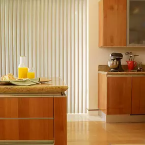 Ready to be enlightened? Then try our Enlightened Vertical Blinds! They’re sleek,  easy to use, perfect for both windows and sliding doors—and they look amazing in this kitchen. #BudgetBlindsKendaleLakes  #VerticalBlinds #FreeConsultation #WindowWednesday