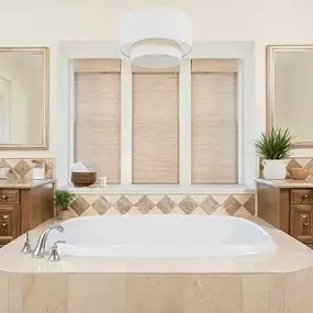 This bathroom features a beautiful mix of textures in matching shades—including our Motorized Woven Shades, which you can open and close with the press of a button!