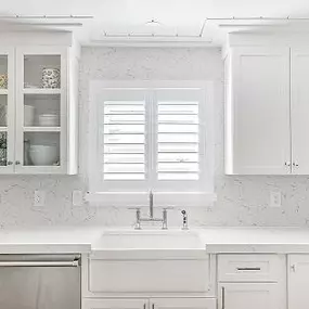 This kitchen is so bright and fresh! We wanted to add another wood element to match the ceiling and cabinetry—and our Plantation Shutters work perfectly!