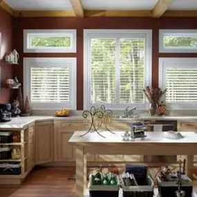 Sun-kissed mornings add a beautiful coziness to this kitchen! Custom Shutters frame the day, allowing you to savor the changing shades of sunlight that perfectly accent your space.