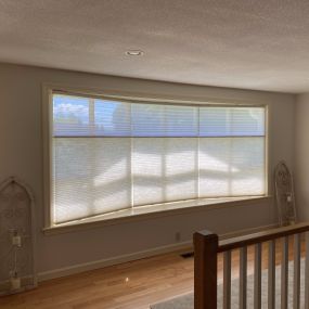 Take a look at these beautiful bow windows from Enfield! You wouldn’t want to cover up that lovely curve with curtains, right? That’s why we installed Honeycomb Trilight Shades!