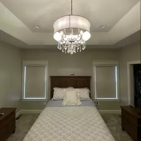 Transform your beautiful bedroom into a haven for soothing sleep. This gorgeous new construction home in Ellington, CT, features Cordless Blackout Roller Shades that make falling asleep easier than ever. #BudgetBlindsEnfield #CordlessShades #RollerShades #ShadesOfBeauty #FreeConsultation