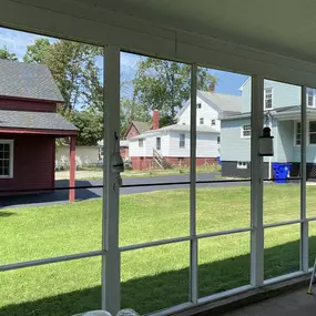 Simple Solar Shades, like the ones in this patio in Windsor, CT add instant elegance and are so versatile — they can be installed in any room of the house! #BudgetBlindsEnfield #WindsorCT #SolarShades #ShadesOfBeauty #FreeConsultation #WindowWednesday