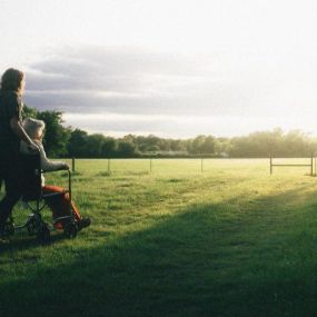 Two people enjoying a sunny day in a field