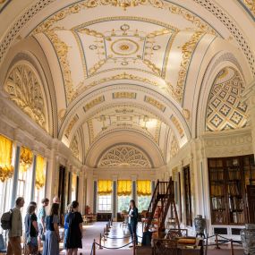 The library at Sledmere House features a stunning ornate ceiling and a rich collection of historic books, a haven for literary and history lovers.