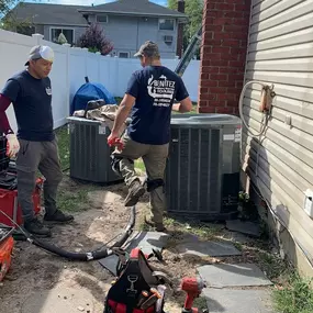 HVAC contractors replacing AC unit