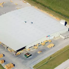 Building materials supplier Builders FirstSource's forklift is moving wood roof trusses.