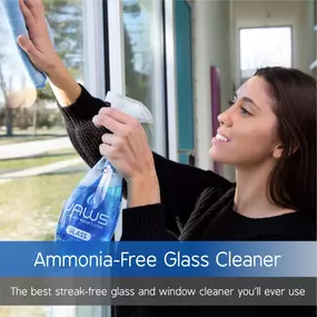 Woman cleaning window with Refillable JAWS Glass Cleaner, an eco-friendly, reusable, and streak-free cleaning product