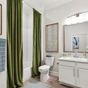 Spacious Bathroom with Marble Countertops & Designer Lighting