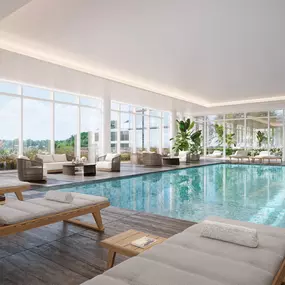 a swimming pool in a building with floor to ceiling windows