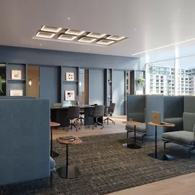 a lounge area with blue chairs and a table in a lobby