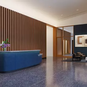 a lobby with a blue reception desk and a chair