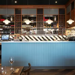 Contemporary Italian dining at Zizzi Bexleyheath with bright, welcoming interiors. Fairy lights light up the ceiling, whilst exotic art walls create a captivating backdrop, energising the dining experience.