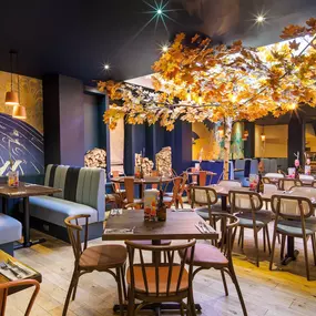 Stylish dining area at Zizzi St Andrews with vibrant colours, modern decor and natural accents.