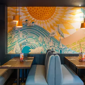 Stylish dining area at Zizzi St Andrews with vibrant colours, modern decor and natural accents.