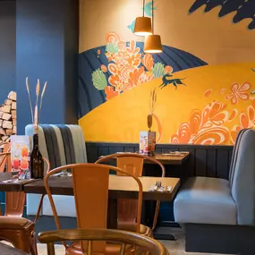 Stylish dining area at Zizzi St Andrews with vibrant colours, modern decor and natural accents.