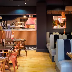 Stylish dining area at Zizzi St Andrews with vibrant colours, modern decor and natural accents.