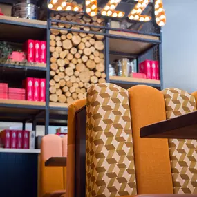 Zizzi Metro Centre, lively interior with vibrant foliage, neon lighting and bold seating.