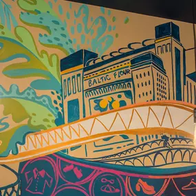Zizzi Metro Centre, lively interior with vibrant foliage, neon lighting and bold seating.