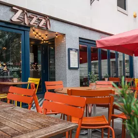 Zizzi Leamington Spa, inviting outdoor seating with greenery and shaded umbrella.