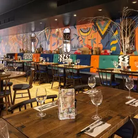 Zizzi Leamington Spa, modern dining space with communal seating and soft lighting.