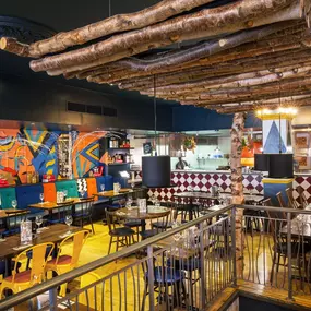 Zizzi Leamington Spa, modern dining space with communal seating and soft lighting.