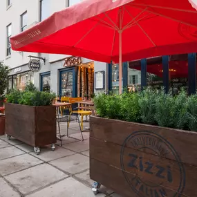 Zizzi Leamington Spa, inviting outdoor seating with greenery and shaded umbrella.