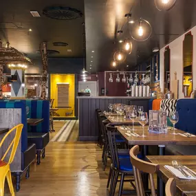 Zizzi Leamington Spa, modern dining space with communal seating and soft lighting.