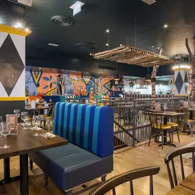 Zizzi Leamington Spa, modern dining space with communal seating and soft lighting.