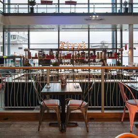 Interior view of Zizzi Leith, bright, open dining with colourful seating and large windows.