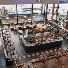 Interior view of Zizzi Leith, bright, open dining with colourful seating and large windows.