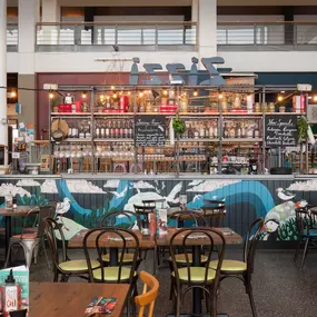 Interior view of Zizzi Leith, bright, open dining with colourful seating and large windows.