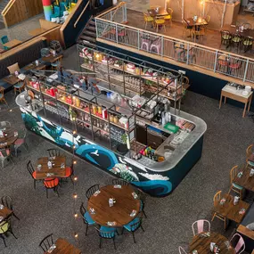 Interior view of Zizzi Leith, bright, open dining with colourful seating and large windows.