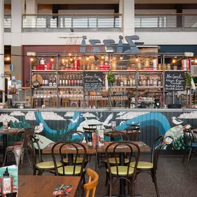 Interior view of Zizzi Leith, bright, open dining with colourful seating and large windows.