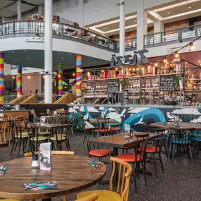 Interior view of Zizzi Leith, bright, open dining with colourful seating and large windows.