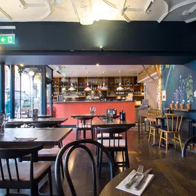 Stylish dining area at Zizzi Canterbury with modern decor and natural accents.