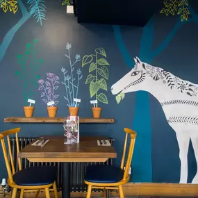 Stylish dining area at Zizzi Canterbury with modern decor and natural accents.