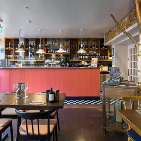 Stylish dining area at Zizzi Canterbury with modern decor and natural accents.