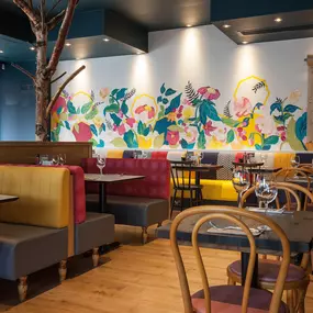 Stylish Zizzi Sutton interior with warm lighting and vibrant décor.