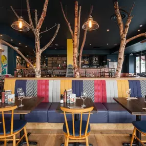 Stylish Zizzi Sutton interior with warm lighting and vibrant décor.