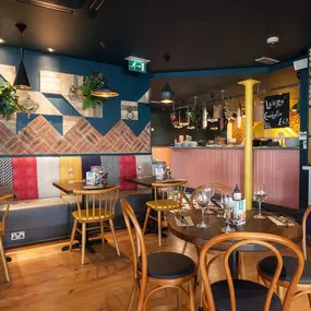 Stylish Zizzi Sutton interior with warm lighting and vibrant décor.