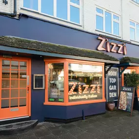 Exterior view of Zizzi Stratford-upon-Avon, classic dark blue frontage mixed with vibrant orange and the iconic Zizzi signage.