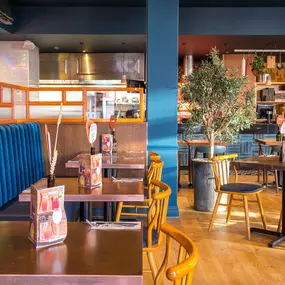 Stylish dining area at Zizzi South Woodford with modern decor and natural accents.