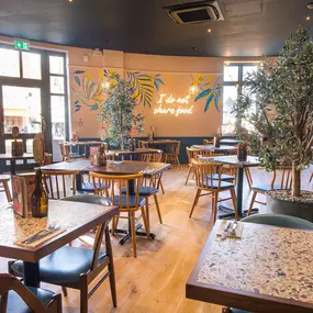 Stylish dining area at Zizzi South Woodford with modern decor and natural accents.